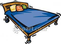 A Bed with Pillows and Blue Sheets - Royalty Free Clipart Picture