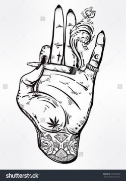 Tattooed hand holding a weed joint or spliff or tabacco cigarette ...
