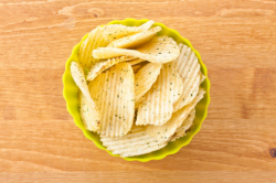 Bowl of potato chips with sour cream and onion flavor - stock photo free