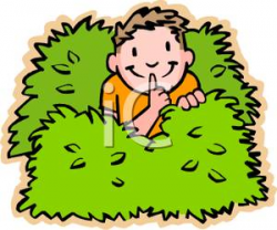 A Young Boy Hiding Behind Some Bushes - Royalty Free Clipart Picture