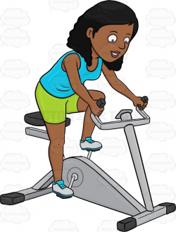 A Dark Haired Woman Enjoys Riding A Stationary Bike ...