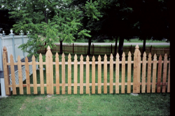 The topped posts on this French gothic cedar picket fence ...