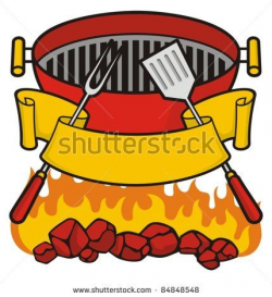 Barbecue grill over flaming charcoal, fork and spatula with ...