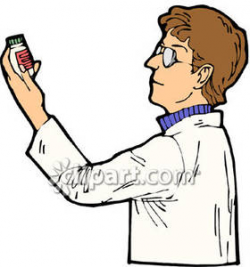 Pharmacist Reading the Label on a Bottle of Medication ...